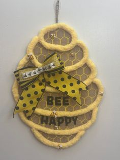 a yellow and black decoration hanging on the wall