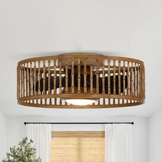 a living room filled with furniture and a round light fixture over a window sill