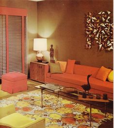 the living room is decorated in orange and yellow colors, with modern decor on the walls