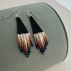 These matte black beaded earrings with ombre ivory fringe are made of high quality Japaneze and Czech beads. They are lightweight and comfortable. These beaded earrings are an amazing gift for special occasions: holidays, birthdays, anniversaries, Christmas, Valentine's Days and more.  This pair is a mix of ethnicity and modern casual style. I create for women who love to feel completely different. -------------------------------------------- ✦ The Details: ✔ Made with quality Czech beads ✔ Made Boho Fringe Earrings, Handwoven Black Beaded Dangle Earrings, Elegant Handwoven Black Beaded Earrings, Elegant Black Handwoven Beaded Earrings, Black Tassel Earrings With Dangling Beads For Festival, Black Beaded Fringe Tassel Earrings For Festival, Bohemian Black Tassel Earrings With Dangling Beads, Black Bohemian Dangle Tassel Earrings, Bohemian Black Tassel Earrings As Gift