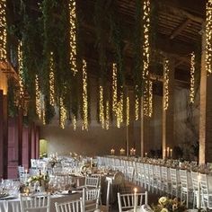 the tables are set with white linens and place settings