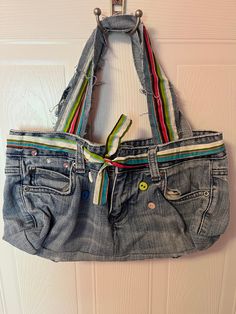 an old pair of jeans hanging from a hook