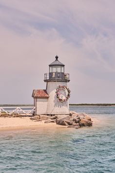 a light house sitting on top of a sandy beach