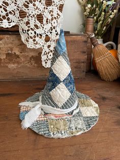 a wizard hat sitting on top of a wooden table next to a lace doily