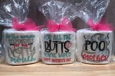 three coffee mugs wrapped in plastic with pink bows and saying'for all the butts, don't give up mother's day '