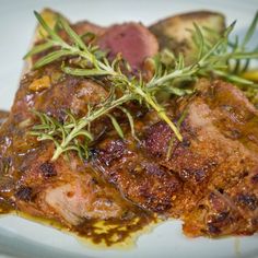 some meat and vegetables on a white plate