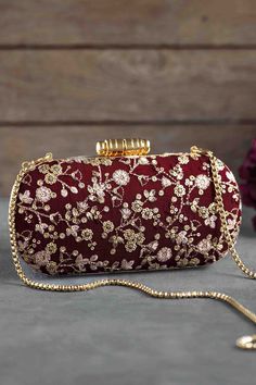 "Everything about this clutch will make you feel so luxe! The silk fabric adorned with gold floral embroidery gives this clutch a royal look. Elan clutch is a versatile, classy and a great additional to your wardrobe that will stick around with you for decades here on. Grab it! Flaunt it! Dimensions (LxB): 8\"x4\" Handle length: 47\" Handle drop: 23\" Material: Embroidered poly silk, suede lining, golden metal clutch frame, golden metal sling. Features: metal lock closure, detachable metal sling." Wedding Arms, Gold Clutch Purse, Wedding Clutch Purse, Side Purses, Flower Handbag, Bridal Purse, Embroidered Clutch, Bridal Bag, Royal Look