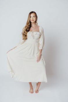 The Juliet Midi Dress is an elegant, ultra-flattering gown that's perfect for any occasion. We just love a 3/4 length sleeve, and the Juliet delivers with a loose, elastic-cuffed sleeves, plus a square neckline and smocked bodice for maximum comfort. Pair with slides for a more relaxed look, or dress it up with neutral heels! FIT: Runs true to size. MATERIAL: GARMENT DETAILS: A-line midi dress with square neckline and 3/4 length sleeves with elasticized cuffs. Features a smocked bodice, accent r Elegant Half Sleeve Dress For Daywear, Elegant Spring Maxi Dress 3/4 Length, Elegant Spring Maxi Dress With 3/4 Sleeves, Elegant Spring Half Sleeve Maxi Dress, Elegant Half Sleeve Maxi Dress For Spring, Spring Wedding Maxi Dress With 3/4 Sleeves, Fall Flowy Half Sleeve Dresses, Flowy Half Sleeve Dress For Fall, Elegant Flowy Maxi Dress With 3/4 Sleeves