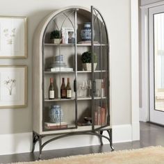 an arched glass display cabinet in a living room