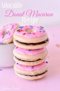 a stack of donuts with pink frosting and sprinkles on top