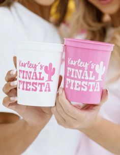 two women are holding cups that say kalepy's final fiesta and final fiesta