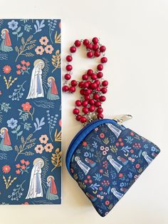 a small purse next to a card and bead necklace