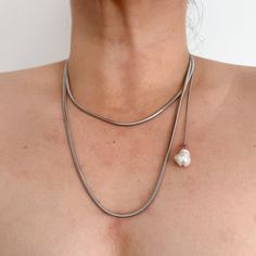 This elegant extra-long necklace is perfect for any occasion. Crafted from 100% stainless steel, it features a high-polish finish and no tarnish. The necklace measures 41.5" long with an additional 2" extension for a versatile fit. A single faux shell pearl is delicately placed on a 9.5" chain on the side, adding a touch of uniqueness and sophistication.  Swap out the faux pearl for fresh water pearl, or your favprite pendant  for an additional $10.  You'll want to wear this beautiful necklace w Silver Long Necklace For Gift, Minimalist Silver Long Necklace As Gift, Silver Long Necklace With Adjustable Chain As Gift, Stainless Steel Lariat Necklace For Gift, Metal Long Necklace With Pearl Chain As Gift, Snake Chain Lariat Necklace As Gift, Silver Long Necklace With Pearl Chain As Gift, Minimalist Silver Long Necklace For Gift, Elegant Metal Chain Necklace For Mother's Day