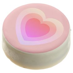 a pink and white round container with two hearts on the top, in front of a white background