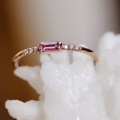 So sweet it'll give you a toothache...our "Rock Candy" ring features a dainty pink sapphire baguette stone accented on either side by pavé set diamonds! - Pink sapphire baguette measures 4mm by 2 mm - 6 Pavé diamonds measure 1mm each - 1.3mm round band - Available in 14K yellow, rose or white Processing times -  Current processing time is 3-5 weeks for this item. Each Item is handmade to order with love and care! In Stock Items -  Contact Liesel Love with any rush order questions, or to see if w Pink Baguette Diamond Rings, Pink Baguette Diamond Rings For Gift, Elegant Pink Sapphire Jewelry Baguette Cut, Elegant Pink Sapphire Baguette Cut Ring, Elegant Pink Sapphire Baguette-cut Jewelry, Pink Stone Rings, Astrology Jewelry, Baguette Diamond Rings, Minimal Jewelry