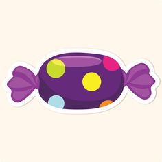 a purple and yellow fish sticker sitting on top of a white surface with polka dots