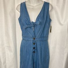 Take A Stand And Declare It. Boss Up And Step Out In This Strap Denim Jumpsuit That Is Sure To Lure Your Boo. It Features Front Buttons And A Tie-Up Top. This Romper Is A Comfortable Outfit That Can Be Worn With Heels Or High Top. Sleeve Style: Strap Size: Small Style: Denim Summer Denim Blue Jumpsuits And Rompers With Button Closure, Denim Blue Overalls With Buttons For Spring, Denim Blue Buttoned Overalls For Spring, Denim Jumpsuits And Rompers With Button Closure For Summer, Summer Denim Jumpsuits And Rompers With Button Closure, Blue Denim Jumpsuits And Rompers With Button Closure, Denim Overall Jumpsuit With Buttons For Summer, Summer Denim Overalls Jumpsuit With Buttons, Summer Denim Blue Overalls With Buttons