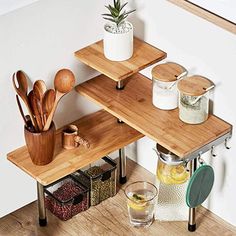 two wooden shelves with utensils and other kitchen items on top of each shelf