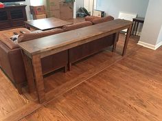 a living room filled with furniture and a flat screen tv on top of a wooden table