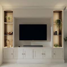 an entertainment center with built - in cabinets and a flat screen tv mounted on the wall