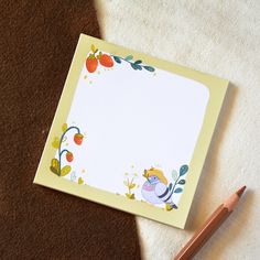 an empty notepad with a pencil next to it on top of a white rug