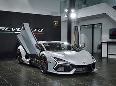 a white sports car parked inside of a building