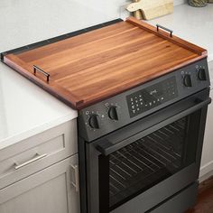 an oven with a cutting board on top of it