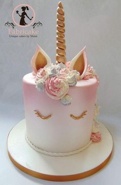 a pink and white cake with a unicorn's horn on top