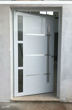 an open white door on the side of a building