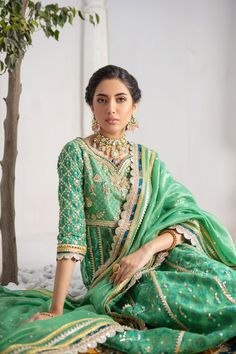 Make a colorful style statement with our beautifully crafted ensemble, gorgeous hand block printed kalidar, heavily embellished with sequins, beads and gota boti chan, neckline and sleeves are beautifully adorned with gorgeous zardozi work, stunning teal & Dhani green hued chata pati appliquéd border on hem finishes it beautifully, gorgeous detailed back and hand-made tassels gives entire outfit a trendy element. This stunning kalidar is offset with jamawar Lehanga and gorgeous Maysuri dupatta featuring gota motifs and heavily embellished chan, trimmed with gota borders , a Must- have wardrobe staple to carry all Wedding Festivities in effortless style. Kalidar Fabric: Pure Silk Net Lehanga Fabric: Jamawar Dupatta Fabric: Pure Maysuri Outfit Color: Opal This outfit is only available in Cus Hem Finishes, Zardozi Work, Wedding Festivities, Pakistani Designers, Colorful Style, Style Statement, Colorful Fashion, Pure Silk, Effortless Style