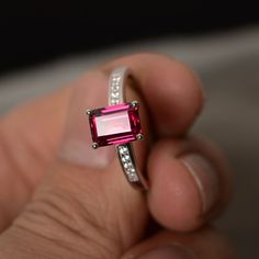 This is a gorgeous handmade creation. Its beauty is its simplicity & Elegance. The 6*8mm emerald cut lab ruby stone is crafted in solid sterling silver and with rhodium plated. It's made to order and it will take about 7-10 days to make it. All item is sent in a beautiful gift box You can realize more lovely stuff clicking the link https://www.etsy.com/shop/knightjewelry?refshopsection_shophome_leftnav Please leave the correct address and you phone number for delivering successfully. Red Gemstone Ring, July Birthstone Ring, Ruby Engagement Ring, Birthday Ring, Red Gemstones, July Birthstone, Anniversary Gift For Her, Diamond Solitaire Engagement Ring, Ruby Ring