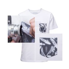 a person holding a camera in front of a t - shirt with pictures on it