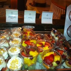 there are many different desserts on the table in this case, including fruit and yogurt