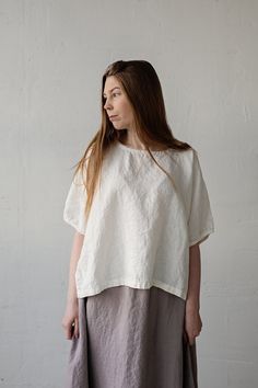 Tunic is made from 100% soft and washed linen. Match it with our skirts! Details: - Composition: 100% Oeko-Tex certified linen - Colour: white - Button in the back - Dropped shoulders - Size: One size/fits all - Medium weight linen - Linen care: machine wash gentle; tumble dry low, ironing optional - The price is for one tunic, other pictured items are not included Measurements: Length from neck down: 55 cm (21,66 in) Chest width: 140 cm (55,1 in) Sleeve length (from collar): 37 cm (14,6 in) Bot White Relaxed Fit Linen Tunic, Oversized Linen White Blouse, Relaxed Fit Ramie Blouse For Daywear, Relaxed Fit Ramie Tops For Daywear, Flax Cotton Relaxed Fit Blouse, Flax Cotton Blouse With Relaxed Fit, White Relaxed Fit Blouse In Ramie, Relaxed Fit Cotton Blouse In Beige, White Relaxed Fit Ramie Blouse