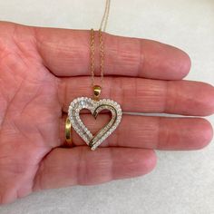 "Up for sale is this vintage estate 10 karat solid yellow gold baguettes and round diamond heart 18\" necklace, never used w/original boxes and tag.  The necklace chain is a delicate pendant chain measuring 18\" long.  The heart pendant features round bezel set diamonds and baguette channel set diamonds set into the heart design (diamonds have been tested genuine).  The attached tag reads 1CTTW AA6/7 10KYG BAG&RD HRT P. The pendant measures 7/8\" wide by 1\" high.  The reverse of the pendant is marked 10K.  The chain closes with a spring ring clasp.  The spring ring is marked 10K.  The necklace was sold to us in the original boxes and the original tag noting $1500 as the original retail price is still attached.  Note that some photos are enlarged to show details. Condition:  This pendant n 14k Gold Heart Pendant Diamond Necklace For Anniversary, Fine Jewelry Stamped 14k For Valentine's Day, Double Heart Brilliant Cut Jewelry Gift, 14k Stamped Jewelry For Anniversary On Valentine's Day, 14k Gold Heart Cut Diamond Accented Jewelry, 14k Gold Jewelry With Heart Cut Diamond Accents, 14k Gold Heart Cut Jewelry With Diamond Accents, Heart Cut Diamond Accent Jewelry In 14k Gold, Stamped 14k Jewelry For Valentine's Day Anniversary