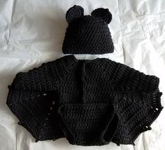 there is a crocheted bear hat and diaper cover on top of each other