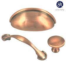 an image of a set of handles and knobs in bronze color for cabinet doors