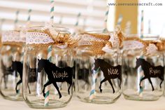 four mason jars with horses on them and straws tied to the lids are decorated with twine