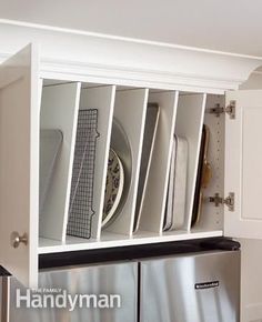 a kitchen with white cabinets and stainless steel refrigerator freezer doors open to reveal dishes