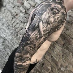 a man's arm with an angel and jesus tattoo on the left side of his body