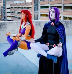 two women dressed in costumes sitting next to each other