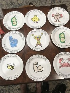 paper plates that have different types of cartoon characters on them with words written on them