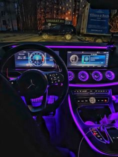 the interior of a car with purple lighting