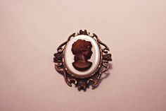 Vintage glass cameo brooch. Good condition, minor wear commensurate to age. See photos for measurements.