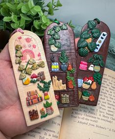 two bookmarks made to look like they are in the shape of houses and gardens