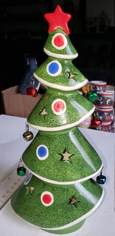 a green ceramic christmas tree sitting on top of a table