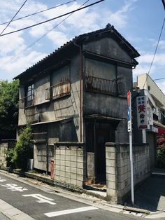 an old run down building on the corner of a street