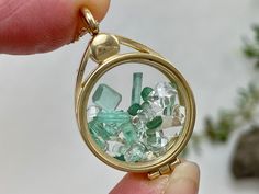 This 14k gold locket has been filled with hand selected natural emerald crystals and faceted gems, accented by natural NY Herkimer Diamond quartz crystals. These are genuine and naturally occurring gemstones from locations around the world, not beads or glass or synthetic stones. This high quality floating locket is US made with 14K gold and glass. You will receive this exact locket and stone selection. Add on a 14k gold chain. The 16" option is pictured. The 18", 20", 24" chain options are slig Round Emerald Jewelry For Healing, Faceted Emerald Gemstones For Gift, Faceted Emerald Gemstones As Gifts, Gold Emerald Gemstones For May Birthstone, Floating Jewelry, Emerald Crystal, Locket Pendant Necklace, Faceted Gems, Gold Locket