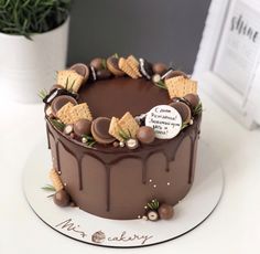 a chocolate cake with cookies and crackers on top