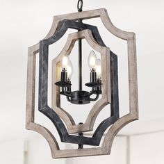 a chandelier with three lights hanging from it's center and an octagonal design